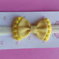 Faixinha gravata pompom - Amarelo